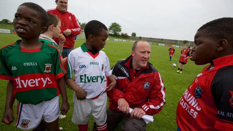 Darren Conlon with children at the Ballyhaunis GAA club’s integration day. Photograph: Keith Heneghan