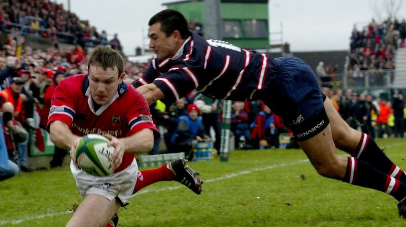 Munster’s John Kelly goes over for a try as Gloucester’s Thinus Delport closes in during Munster’s thrilling victory in the 2003 Heineken Cup. Photograph:  Morgan Treacy/Inpho