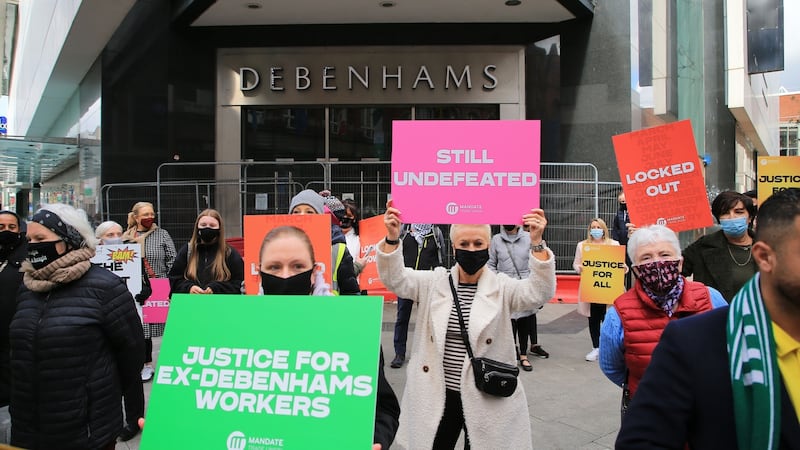 Former Debenhams workers hold up banners outside of the closed store on Henry Street, Dublin. Photograph:  Nick Bradshaw