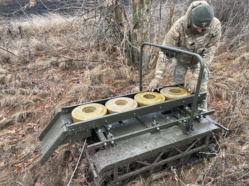 A drone operator and technician with Ukraine's 113th territorial defence brigade, with the Ukrainian-made Volya-E land drone. Photograph: Daniel McLaughlin