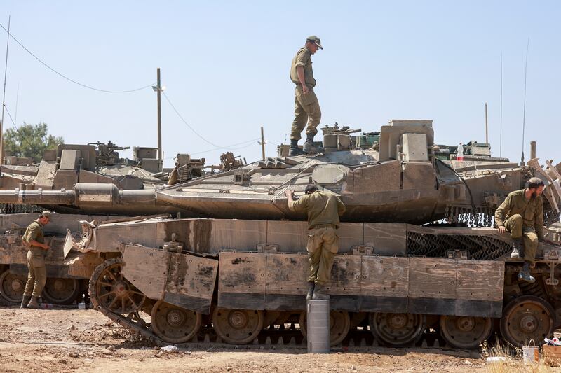 Israeli soldiers carry out maintenance on tanks near the Gazan border on April 16th. Photograph: Menahem Kahana/AFP via Getty