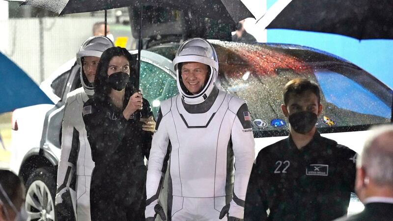 Nasa astronaut Tom Marshburn smiles as he stands under an umbrella after leaving the Operations and Checkout Building for a trip to Launch Pad 39-A at the Kennedy Space Center. Photograph: John Raoux/AP