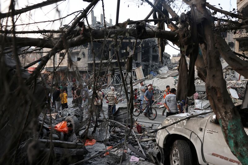 Palestinians watch rescue efforts on the rubble of a building following overnight Israeli strikes on the Rafah refugee camp in the southern Gaza Strip on  Wednesday. Photograph: Mohammed Abed/ AFP via Getty Images