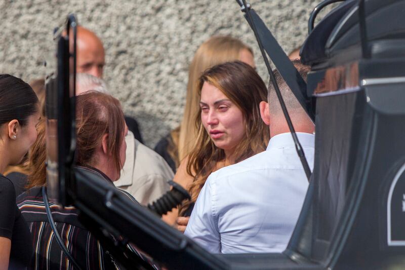 Robbie O'Connor's sister Kylie is comforted at the funeral by mourners at the Church of Our Lady Immaculate, Darndale.