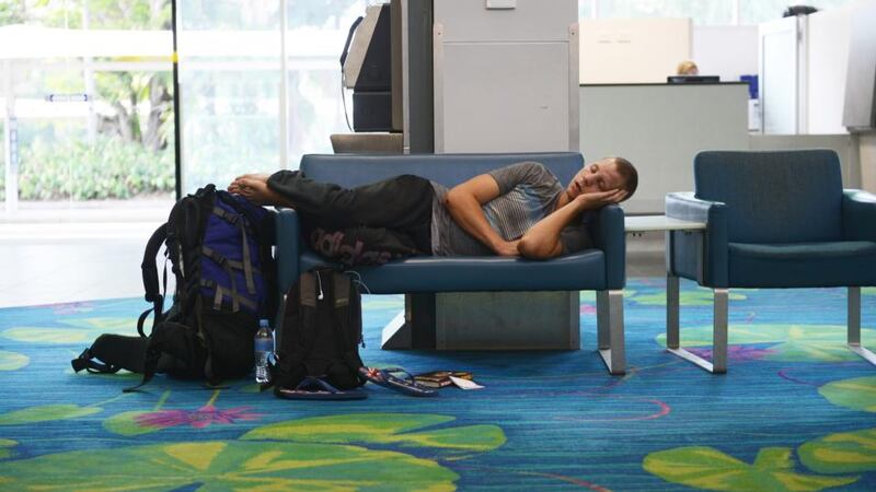 A passenger sleeps in Darwin airport today. Flights in and out of Darwin have been suspended as volcanic ash from Mount Sangeang volcano covers much of northern Australia. It is expected flights will be cancelled form Darwin until Monday. Photograph:  Elise Derwin/Getty Images
