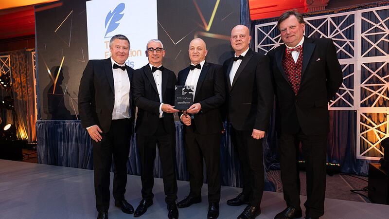 Joseph Collins, awards judge, presents the best online learning experience award to the Munster Technological University team