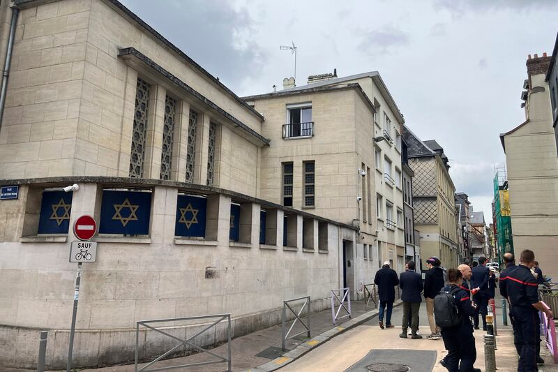 Firemen stand in front the synagogue on Friday. Photograph: Jeffrey Schaeffer/AP