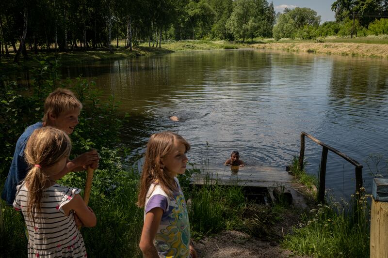 Children visit a pond in Moshchenka, Ukraine, on June 10th. Photograph: Nicole Tung/New York Times