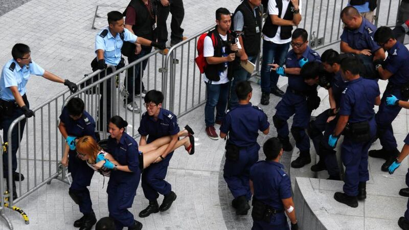 Protesters are dragged away by police after storming into government headquarters in Hong Kong. Photograph: Reuters