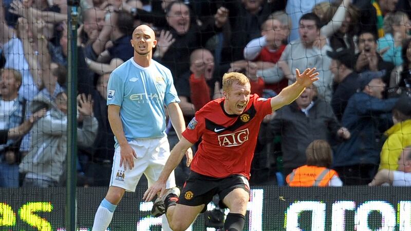 Stephen Ireland looks on as Paul Scholes celebrates scoring a last minute winner in the Manchester derby in April 2010. Photograph: Andrew Yates/Getty/AFP