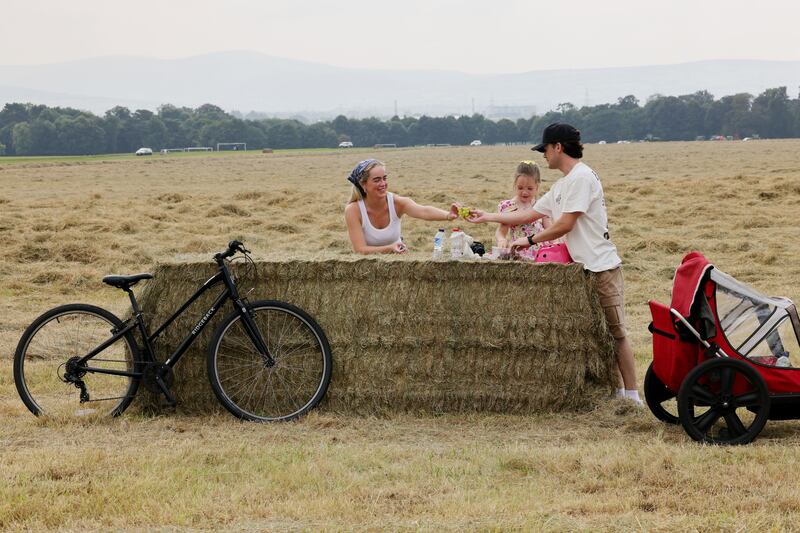 Angel Kelly and David Duffy with Kydi Kelly (6) from Dublin take a snack break in Dublin's Phoenix Park. Photograph: Alan Betson