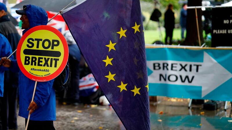 An anti-Brexiteer holds an EU flag near pro-Brexit banners outside the Houses of Parliament in Westminster, central London on October 17th, 2019. Photograph: Tolga Akmen/AFP via Getty Images