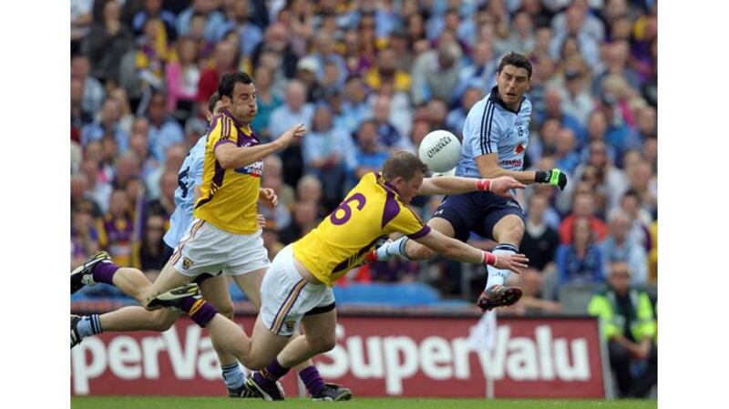 Bernard Brogan has a shot charged down by Wexford captain David Murphy during the 2011 Leinster SFC final at Croke Park. Photograph: Colm O'Neill/Inpho