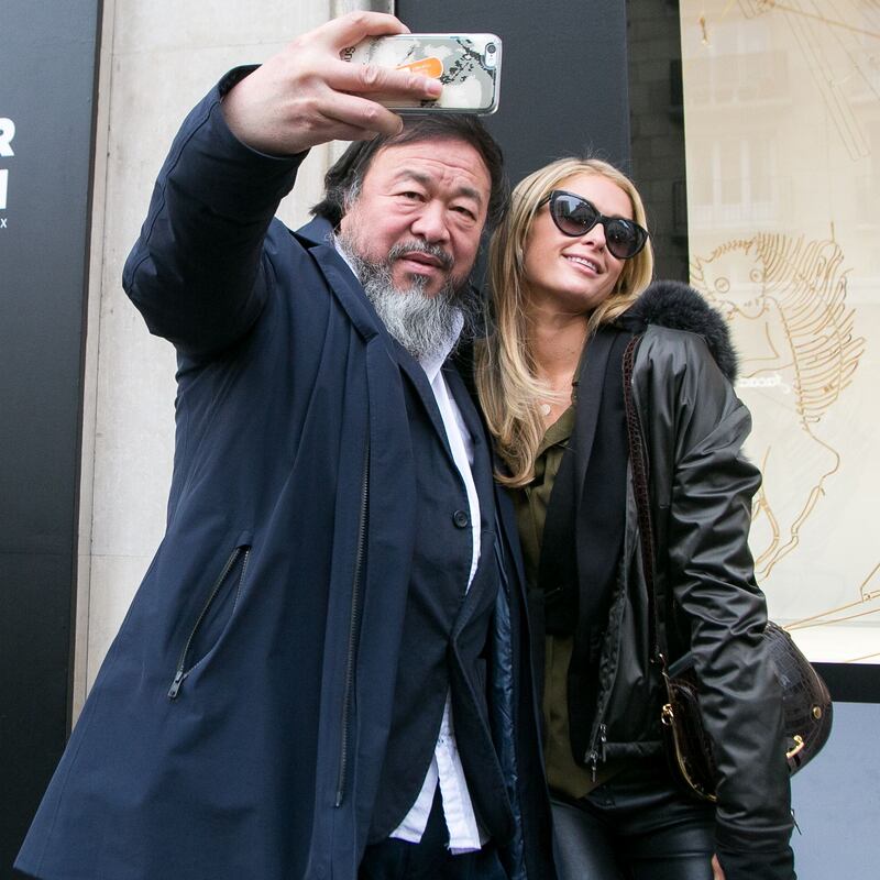Ai Weiwei posing for a photo with Paris Hilton. Photograph: Marc Piasecki/GC Images