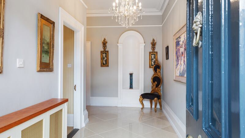The smart door opens into a noticeably wide hall floored in polished marble