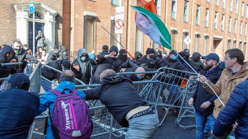 Counter-demonstrators (left) clash with activists protesting against the Government’s imposed restrictions put in place to help stem the rise in the number of  Covid-19 cases outside Leinster House on Saturday. Photograph: Paul Faith/AFP via Getty
