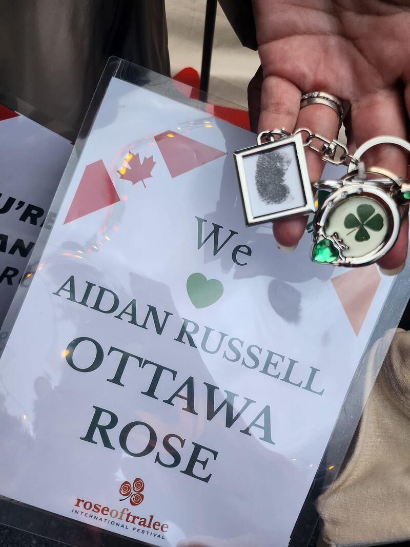 Tracy Woodcock Russell shows her good luck charms as well as her sign for her daughter Aidan Russell