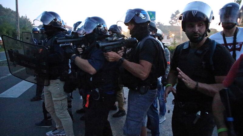 French police officers prepare to fire teargas toward anti-G-7 activist near a tent camp near Hendaye, France on Friday. Photograph: Bob Edme/PA
