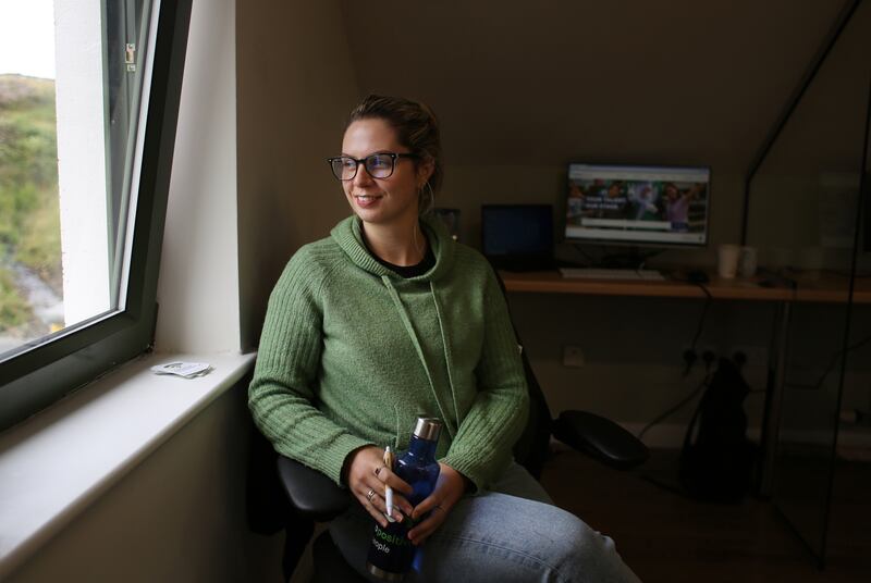 Saoirse O’Malley at work at a ‘hot desk’ in the Clare Island Living Lab. The co-working space, has ten hot desks, free high-speed broadband, high spec seating, lighting, and heating. She works as a Talent Acquisition Advisor for PepsiCo, the American multinational food, snack, and beverage corporation. Photograph: Bryan O'Brien 