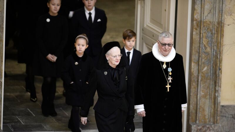Danish Queen Margrethe (L) is led into the church by royal confessor Erik Norman Svendsen. Photograph: Mads Claus Rasmussen DENMARK OUT/AFP