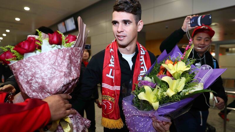 Former Chelsea midfielder Oscar arrives at Shanghai airport to join Shanghai SIPG following his €60m transfer.  Photograph: AFP/Getty Images.