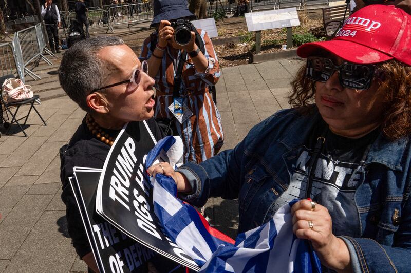 Anti-Trump and pro-Trump demonstrators jostle outside Manhattan Criminal Court on the first day of the former president's criminal trial. Photograph: Adam Gray/AFP via Getty Images