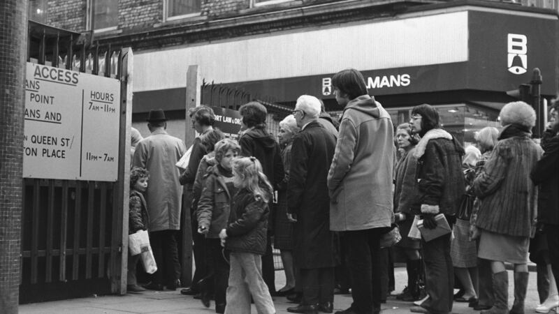 Businessmen and shoppers queue at Fountain Street to enter Belfast city centre in  April 1972. The so-called ‘ring of steel’ security cordon encloses Belfast’s main shopping streets and protects the city’s commercial heart from terrorist bombings. Photograph:  Alex Bowie/Getty Images