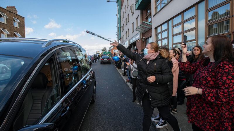 Mourners throw flowers onto the hearse of Fergus McCabe at Summerhill. Photograph: Colin Keegan/Collins Dublin