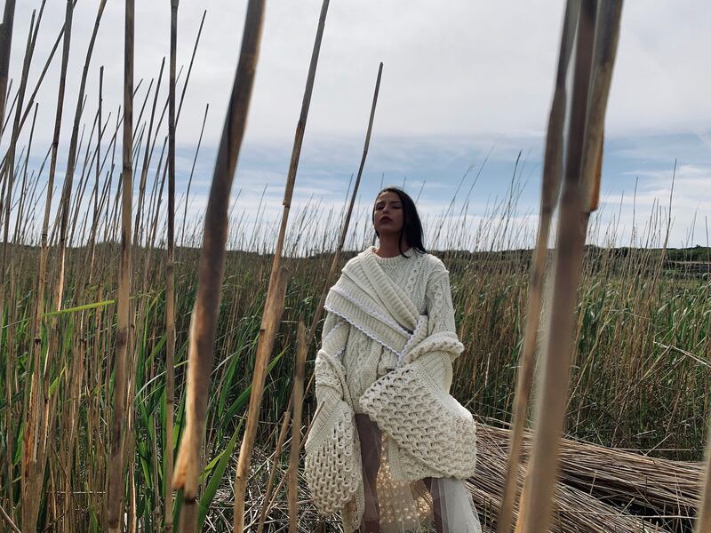 Hand-crochet coat with rib and wave stitch, handknitted asymmetric Aran jumper with hand-crochet trim in ivory Donegal yarn, €1,295.