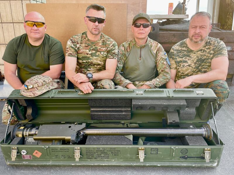 Ukrainian supreme court judges Vitaliy Zuyev, Yuriy Chumak and Mykola Gimon and constitutional court judge Viktor Kichun (second from right) with a Stinger anti-aircraft missile. From a Kyiv rooftop, their volunteer unit tries to shoot down Russian drones and missiles flying towards the city. Photograph: Daniel McLaughlin