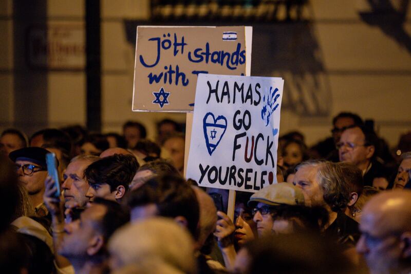People attend a commemoration ceremony for the victims in Israel held by the Jewish community in Vienna, Austria: The death toll in Israel has reached 1,200 and the military said the figure would continue to rise with more discoveries of bodies of civilians killed by the Hamas fighters who breached the Gaza border.
