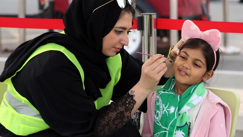 A young girl has her face painted ahead of the Saudi Pro League match between Al-Ahli and Al-Batin. Photograph: AFP