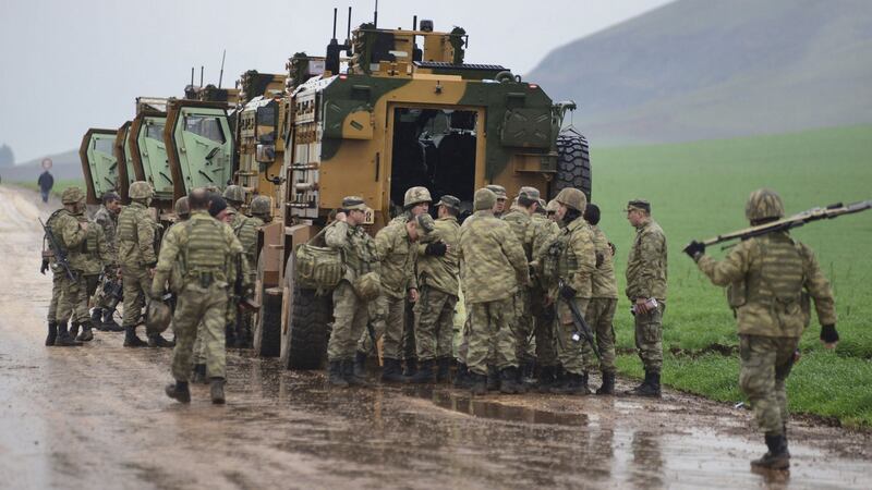 A convoy of Turkish armoured personnel carriers near the border with Syria. Photograph:   AP