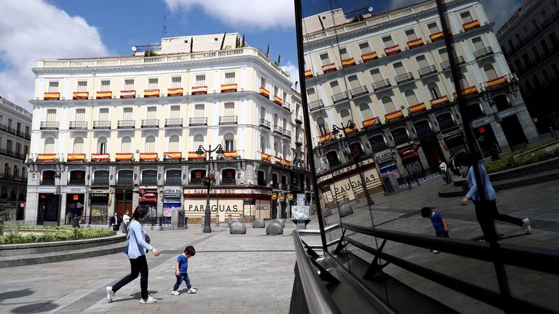 Family members walk by Puerta del Sol square in the Spanish capital  after restrictions were partially lifted for children. Photograph: Reuters