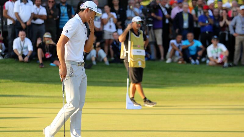 Li Haotong puts his hand to his face after three-putting on the first playoff hole. Photo: Warren Little/Getty Images