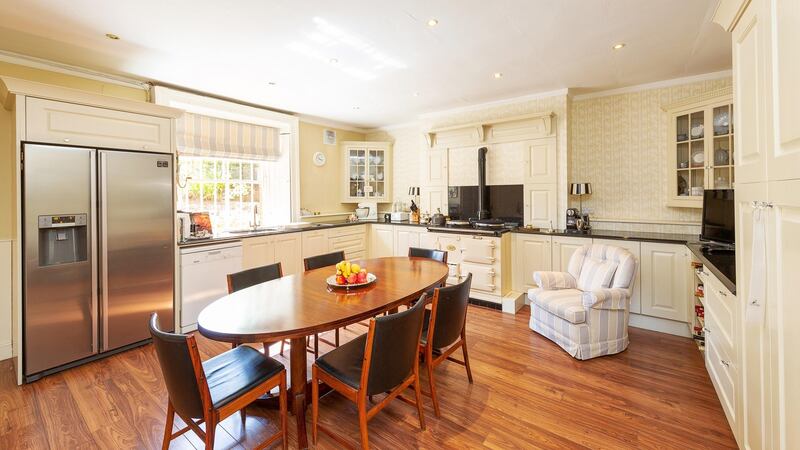 The kitchen is warmed by an Aga, and the utility room has outdoor access