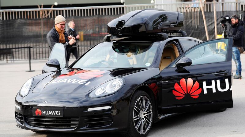 A driverless Porsche controled by Huawai’s Mate 10 Pro handset, which transforms a regular car into a self-driving vehicle. 