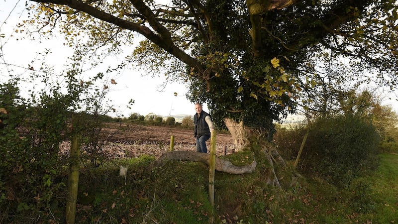 David Crockett by a ditch that divides his farm between Co Derry and Co Donegal. Photograph: Trevor McBride