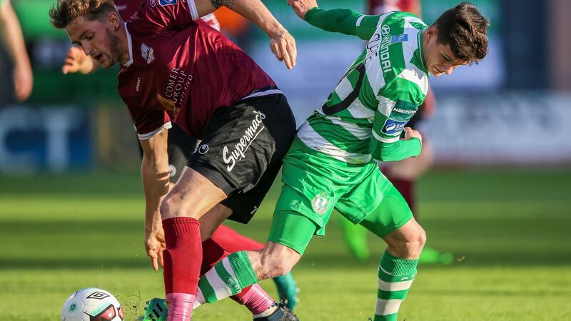 Trevor Clarke and Lee Grace battle for possession. Photograph: Inpho