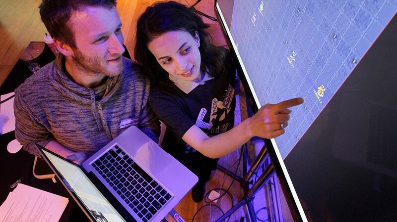 Participants discuss strategy at the Openet De/Coding contest at the Guinness Storehouse in Dublin