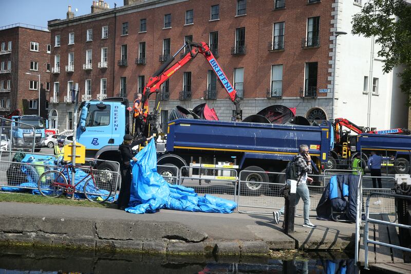 An operation got under way again this morning to clear tents at the Grand Canal Dublin after offers of accommodation were made to about 90 asylum seekers. Photograph: Stephen Collins/Collins