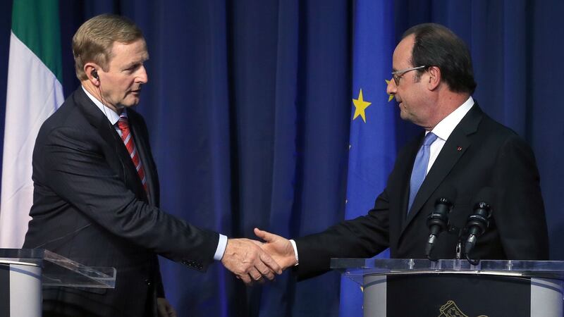 French President Francois Hollande (right) and Taoiseach Enda Kenny shake hands during a press conference at Government Buildings in Dublin. Photograph: PA