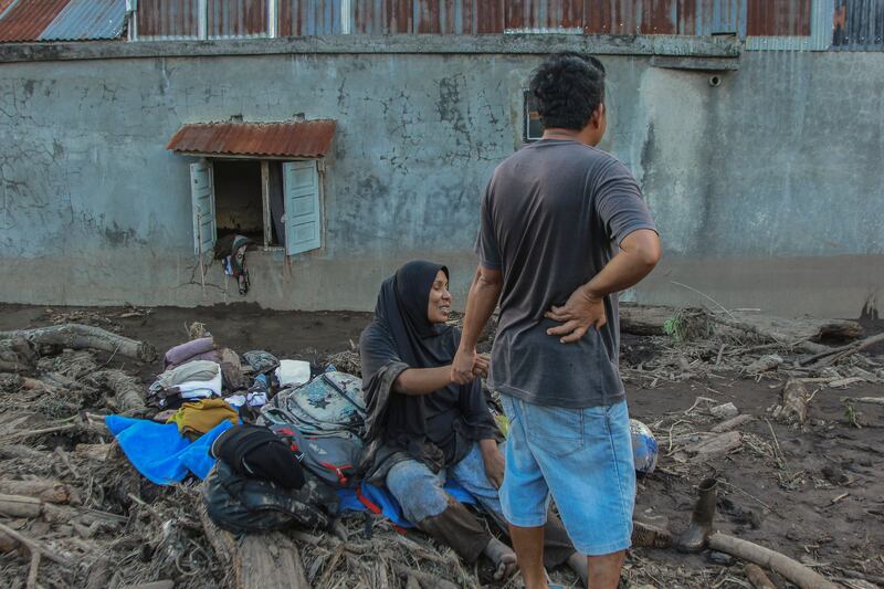 Villagers collect their belongings following a flash flood in Tanah Datar, West Sumatra, Indonesia, 12 May 2024.