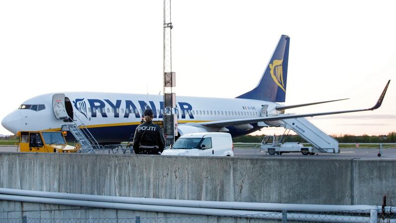 A police officer stands guard near a Ryanair plane on Rygge Airport in Norway, where a police bomb squad was deployed to check a plane and had two passengers escorted from the aircraft for what was reported as ‘strange behaviour’. Photograph: EPA