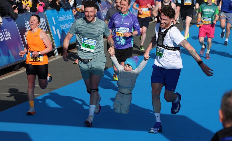 Racers cross the finish line with a little helping hand. Photograph: Stephen Collins/Collins Photos
