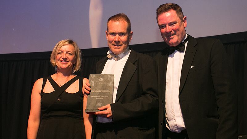 Martin Murray, Regional Sales Manager, Ayrton Group presents the Building Refurbishment for a Single Building or Development to Fintan Duffy and Máire Henry, dhbArchitects.