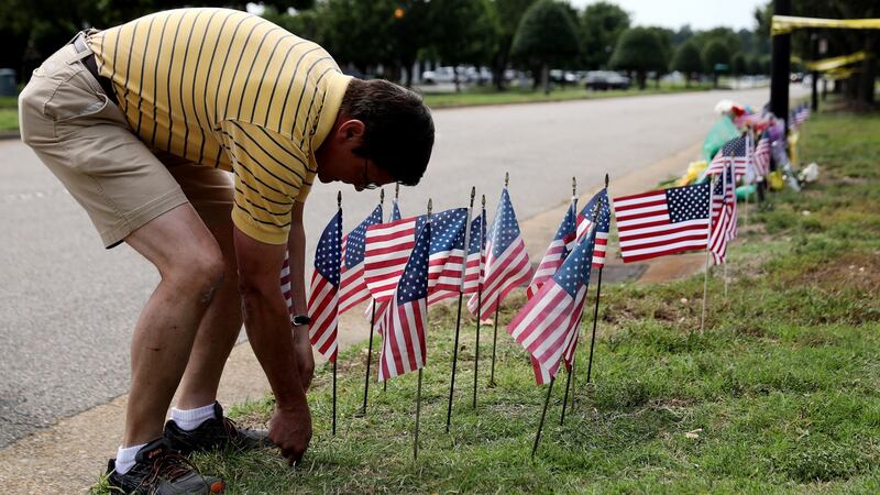 Rich Lindgren places 12 US flags in the ground at a makeshift memorial outside  the  scene of a mass shooting at the Virginia Beach Municipal Center,   Virginia Beach, Virginia. Photograph: Chip Somodevilla/Getty