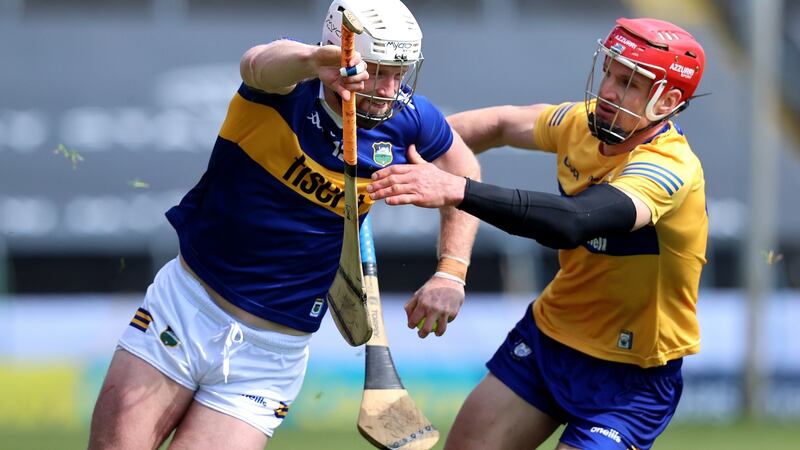 Tipperary’s Michael Breen and John Conlon of Clare during the Munster senior hurling championship, round two, at Semple Stadium, Co Tipperary. Photograph: Bryan Keane/Inpho