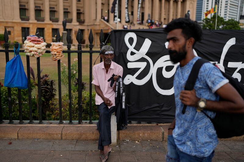 A man sells hand bands which read ‘Ranil Go home’ at the protest site in Colombo. Photograph: AP