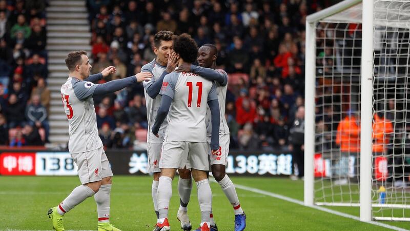 Salah celebrates scoring Liverpool’s first goal with Naby Keita, Roberto Firmino and Xherdan Shaqiri. Photo: Peter Nicholls/Reuters